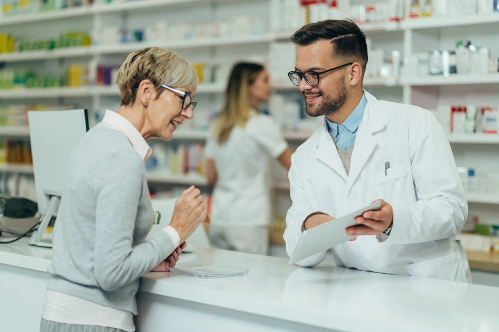 is owning a pharmacy profitable - man showing pharmacy consultant the pharmacy profit margins