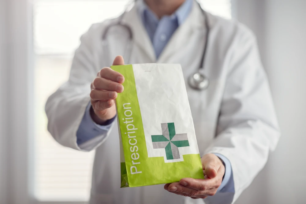 pharmacist holding a prescription Rx bag with creative pharmacy branding