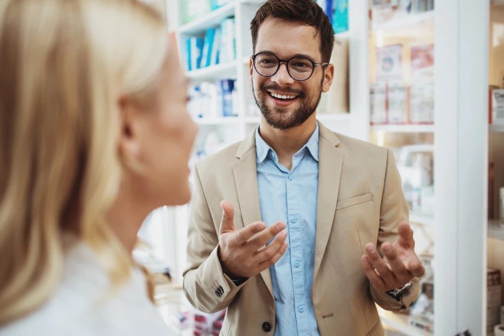pharmacy business owner talking to a pharmacist