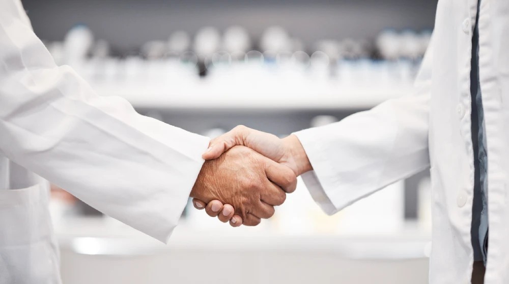 two pharmacists shaking hands