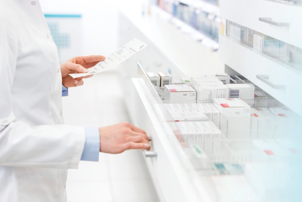 pharmacist taking inventory of their prescription medication stock to determine pharmacy profits