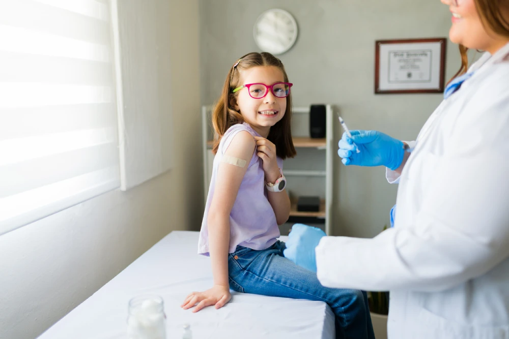 pharmacist giving young child a flu shot 