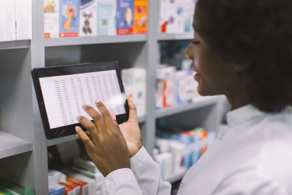 pharmacist looking at pharmacy product data