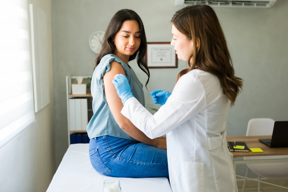 pharmacist prepping a patient for a flu shot