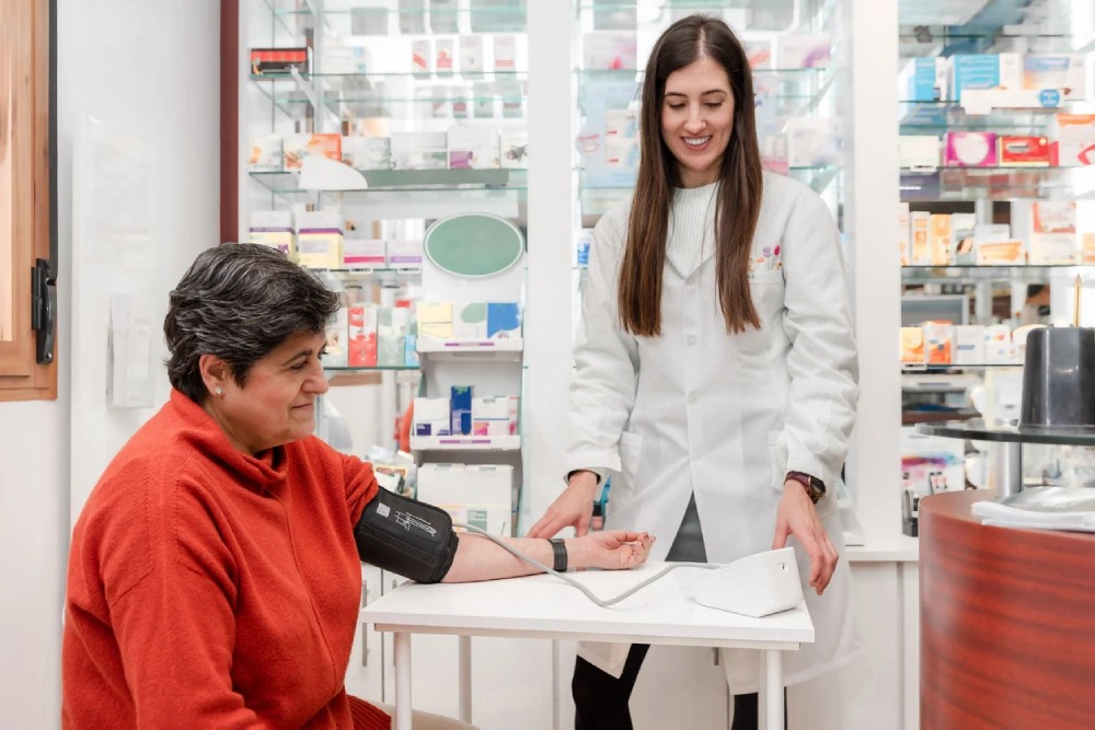 woman getting her blood pressure taken by a pharmacist