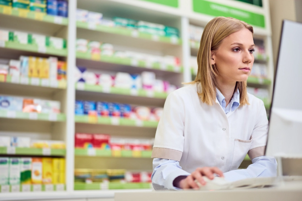 pharmacist on a computer - pharmacy compliance in canada