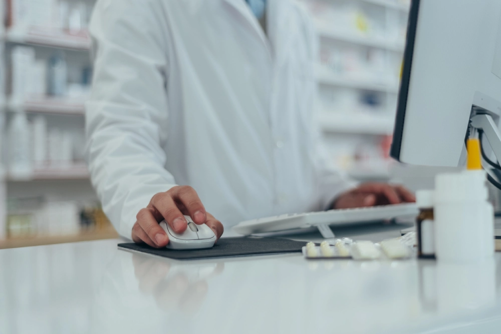 pharmacist on a computer - data protection as part of pharmacy compliance in canada