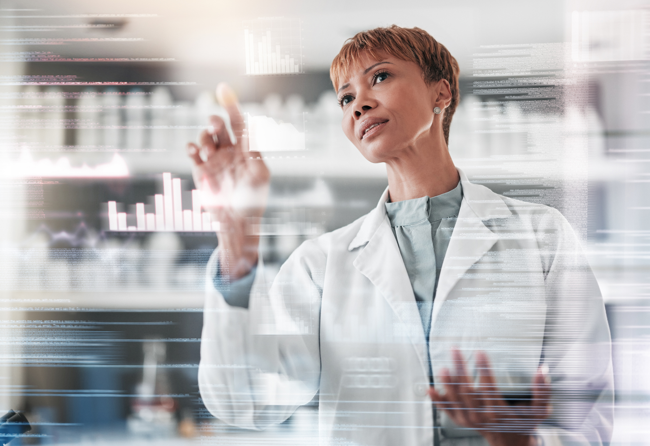 A female pharmacist scrolls through data on a futuristic screen.