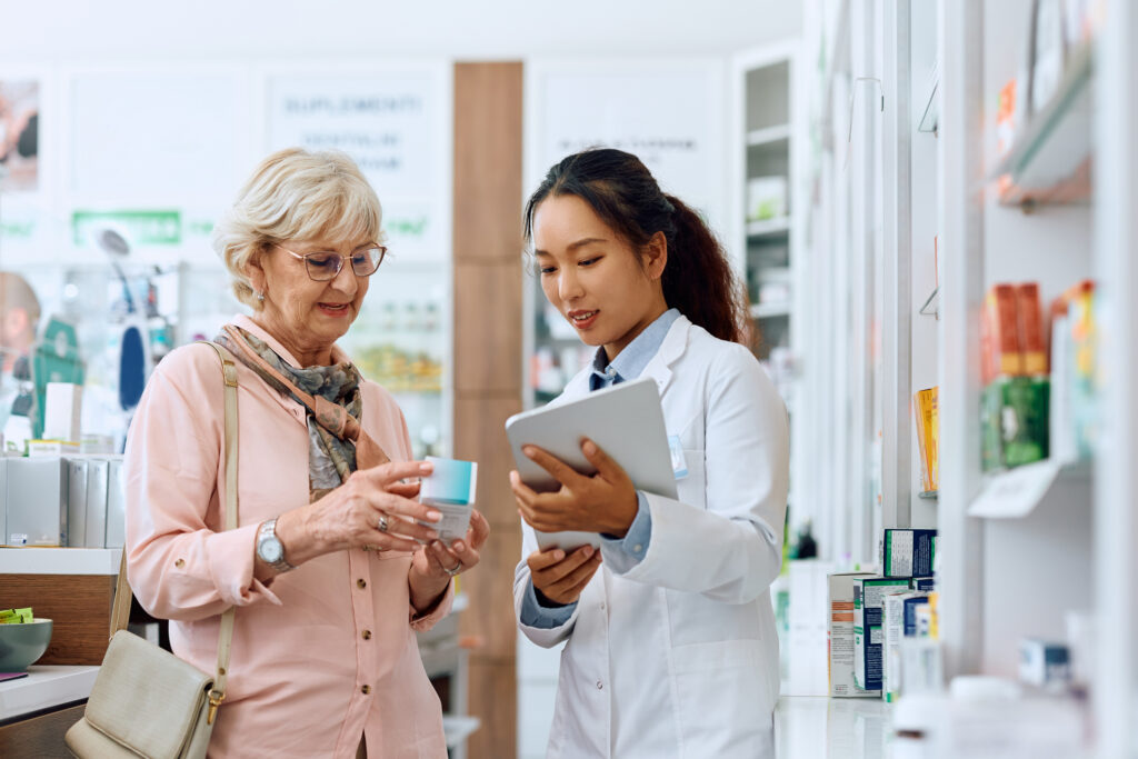 A female pharmacist counsels an elderly patient. 