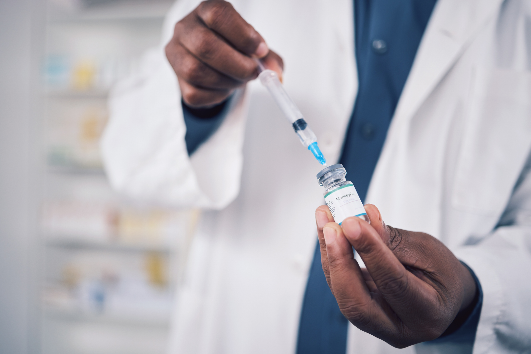 A pharmacist's hands are preparing an immunization.