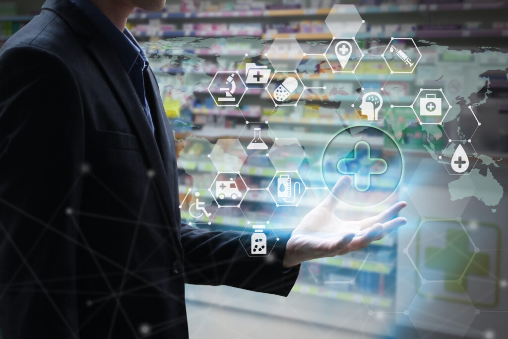 A professional man holds a virtual screen containing healthcare icons.