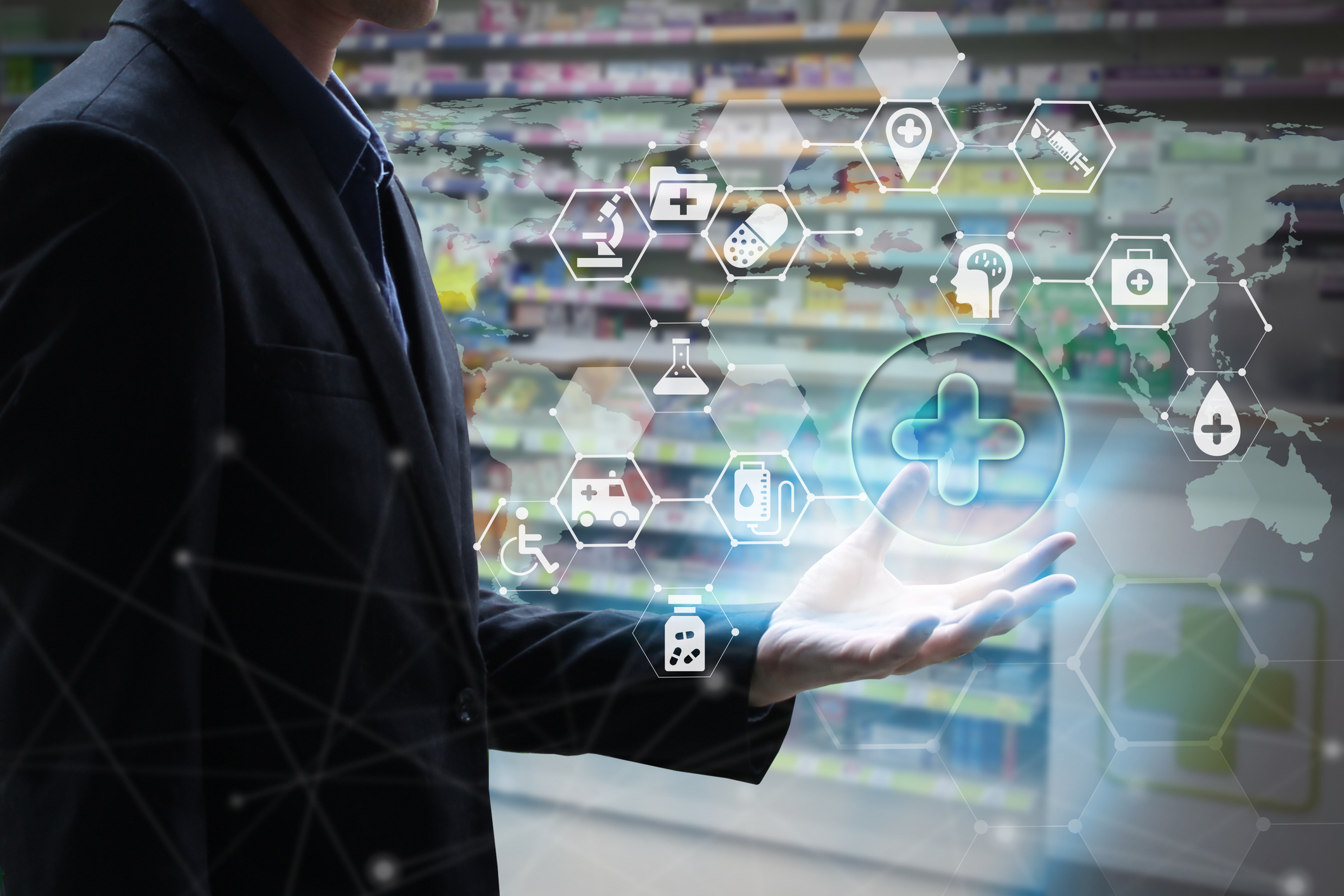 A professional man holds a virtual screen containing healthcare icons.
